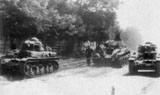 Two R-35 tanks tow a captured BT-2 in Bessarabia. July 1941.