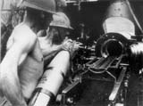 Gunners operating a 150mm Skoda M1934 heavy field howitzer. They are wearing Adrian M1916 helmets, specific of auxiliary troops. Bessarabia, July 1941.
